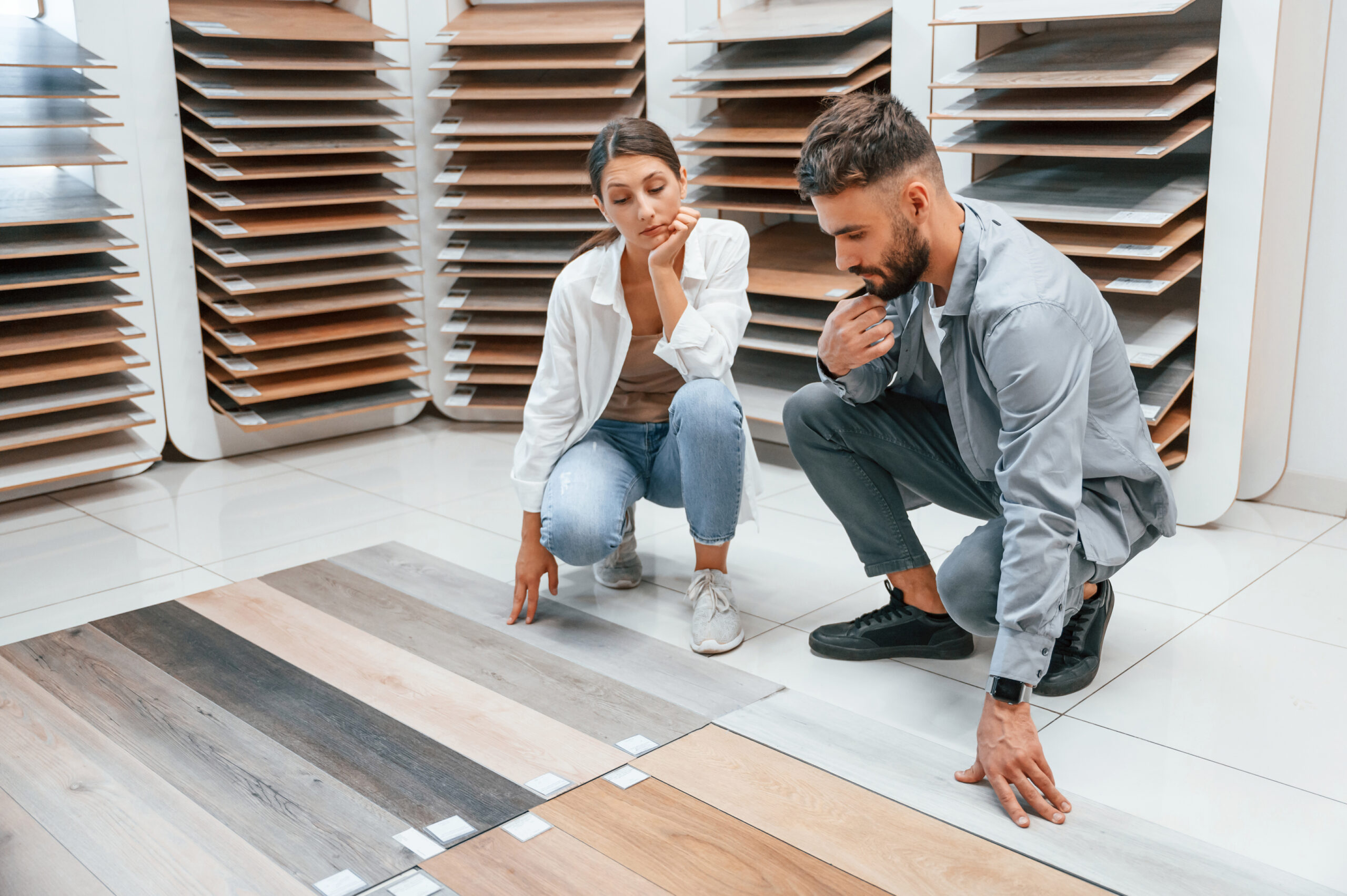 Choosing parquet. Woman and man is in the store of goods for the home.