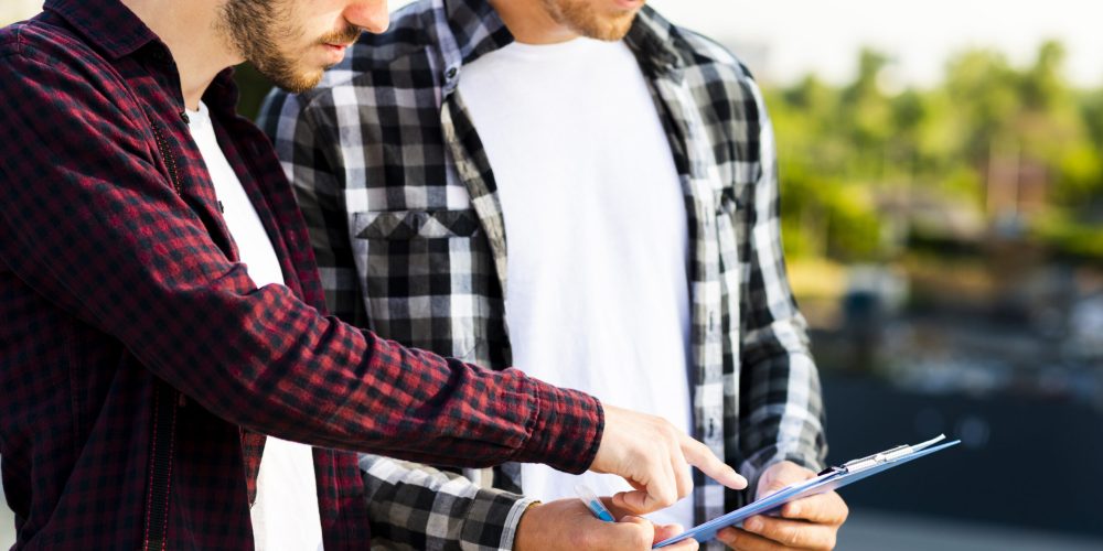 close-up-engineer-architect-looking-clipboard